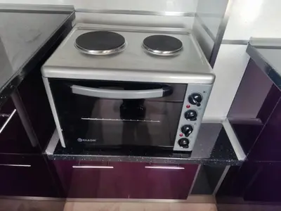 a microwave oven in a kitchen with purple cabinets at Mountain view apartment in Sofia