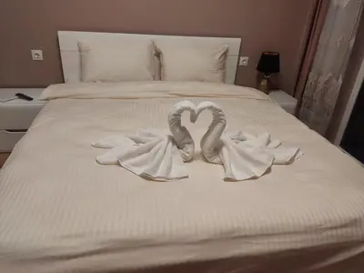 two towels in the shape of hearts on a bed at Mountain view apartment in Sofia