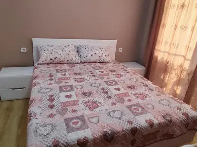 a bedroom with a bed with a quilt on it at Mountain view apartment in Sofia