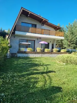 a house with a large yard in front of it at Къща за гости Радост Guest House Radost in Razlog