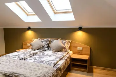 a bedroom with a bed and a skylight at Семеен хотел При Вергил in Sapareva Banya