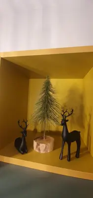 a shelf with a small tree and two figurines on it at FOX boutique apartment Borovets Gardens in Borovets