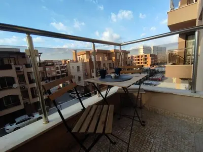 a balcony with a table and a bench on a balcony at Your place in Plovdiv