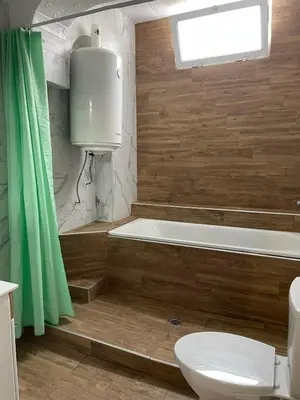 a bathroom with a tub and a toilet and a sink at THE CENTER Apartments Comfort in Sandanski