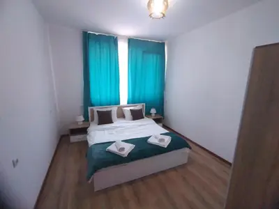 a bedroom with a bed with two towels on it at THE CENTER Apartments Comfort in Sandanski