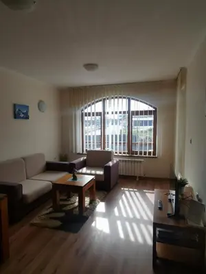 a living room with a couch and a coffee table at Sunny home by the lift in Bansko in Bansko