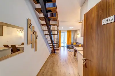an asx sign on a door in a hallway with a living room at Skyday Penthouse Deluxe at Oak Residence in Smolyan