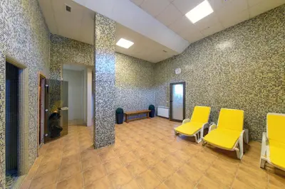 a waiting room with two yellow chairs in a room at Skyday Penthouse Deluxe at Oak Residence in Smolyan