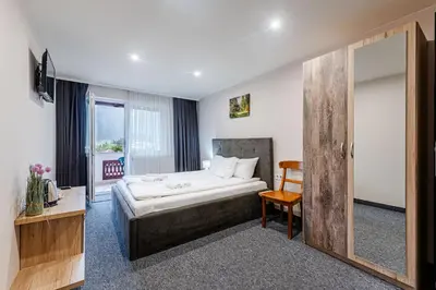 a hotel room with a bed and a window at Ardo Spa Hotel and Restaurant in Sarnitsa