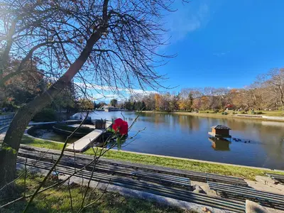 a view of a river with a boat on it at Riverpark Holiday Apartment, Sandanski in Sandanski