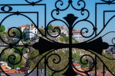 a view of a city through a gate at VIZUALIZA Residence Hotel by HMG in Plovdiv