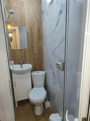 a bathroom with a toilet and a sink and a shower at THE CENTER Apartments Comfort 3 in Sandanski