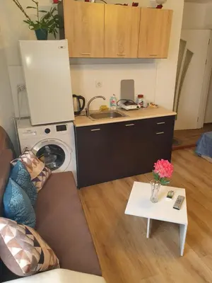 a kitchen with a washing machine and a table at THE CENTER Apartments Comfort 3 in Sandanski