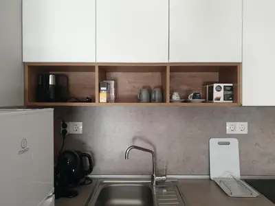 a kitchen counter with a sink and white cabinets at Pirotska 47 apartment in Sofia