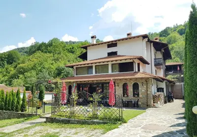 a house with a fence in front of it at Family Hotel Chiflik Hills in Chiflik