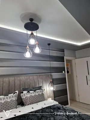 a bedroom with blue and gray striped walls at Victoria apartments 3 in Velingrad