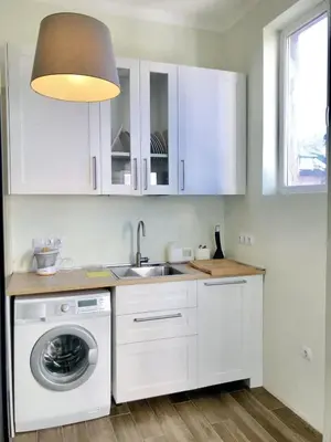 a kitchen with a sink and a washing machine at Charming Apartment Sofia 100m² in Sofia