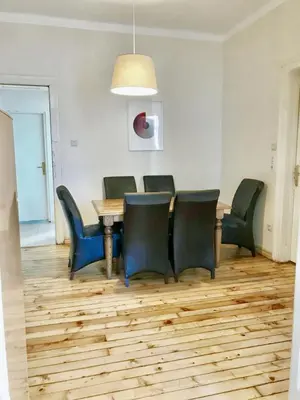 a dining room with a wooden table and chairs at Charming Apartment Sofia 100m² in Sofia