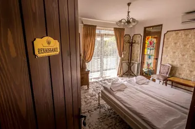 a bedroom with a bed and a sign on a door at Tihiat Kut Complex in Kyustendil