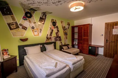 a bedroom with a large bed and a chair at Tihiat Kut Complex in Kyustendil