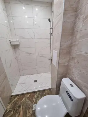 a bathroom with a toilet and a shower at Luxury two bedroom Crown apartament in Botevgrad