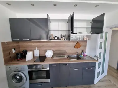 a kitchen with a sink and a washing machine at Luxury two bedroom Crown apartament in Botevgrad