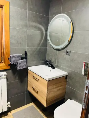 a bathroom with a sink and a mirror at Апартаменти за гости ,,Friends