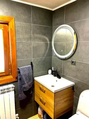 a bathroom with a sink and a mirror at Апартаменти за гости ,,Friends