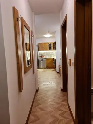 a hallway of a room with a kitchen and a hallway at Pirin Golf Apartment HOME with private garden in Bansko