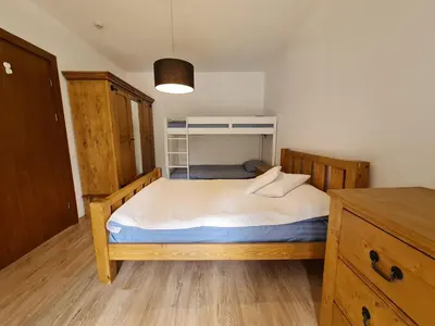 a small bedroom with a bed and a cabinet at Pirin Golf Apartment HOME with private garden in Bansko
