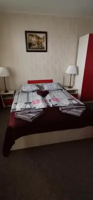 a large bed in a room with two lamps at Grand Monastery Pamporovo Apartment for rent in Pamporovo