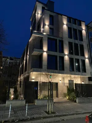 a tall building with lights on it at night at DV13 Luxury Suite Sofia Center in Sofia