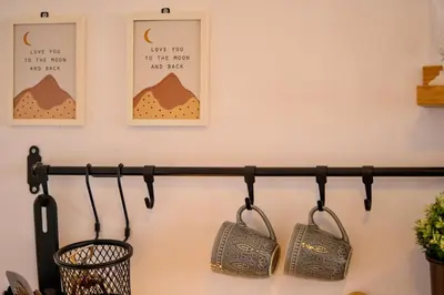 a black metal towel rack with three bags on it at Studio 9, St John Park in Bansko
