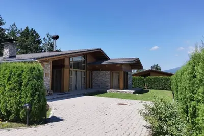 a house with a stone driveway in front of it at MAGNET - private chalet in Razlog