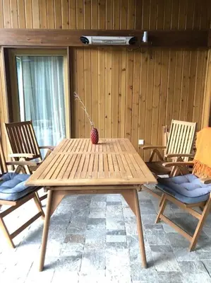 a wooden table with two chairs at MAGNET - private chalet in Razlog