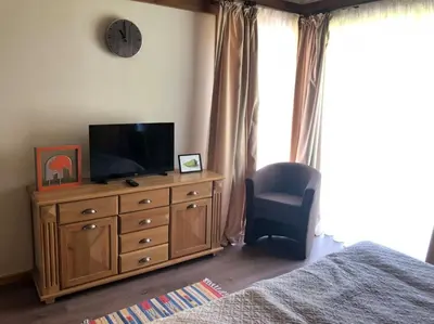 a bedroom with a dresser with a television on it at MAGNET - private chalet in Razlog