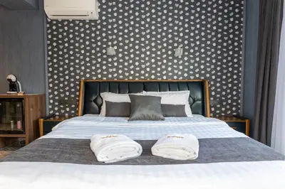 a bedroom with a bed with two towels on it at HIDDEN BANK: DIAMONDS in Plovdiv