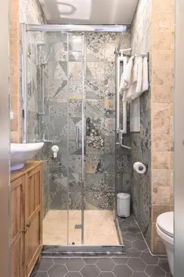 a bathroom with a shower with a sink and a toilet at Floral Studio Retreat in Sofia City Center by Flat Mаnager in Sofia