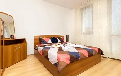 a bedroom with a bed with a dresser and a mirror at Lovely 1BD Apartment close to the Summer Theatre by Flat Mаnager in Plovdiv
