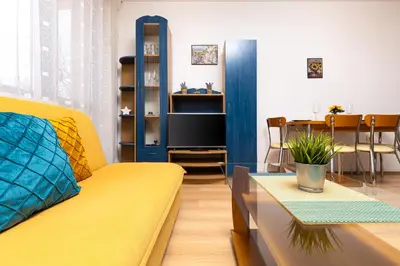 a living room with a yellow couch and a table at Lovely 1BD Apartment close to the Summer Theatre by Flat Mаnager in Plovdiv