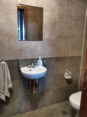 a bathroom with a sink and a toilet at Kolimechkov Apartments Borovets in Borovets