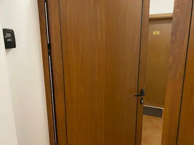 a wooden door in a room with a hallway at GrandView Apartment Grand Monastery in Pamporovo