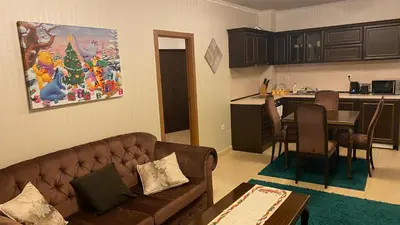 a living room with a couch and a kitchen at GrandView Apartment Grand Monastery in Pamporovo