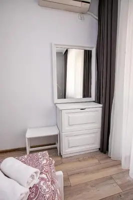 a bedroom with a dresser with a mirror and a bed at Paradise Apartment in Sandanski