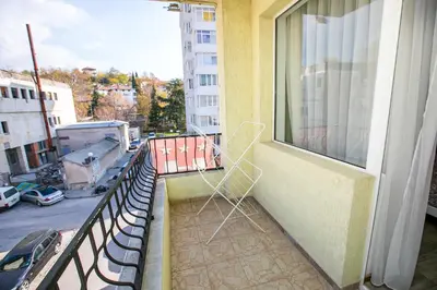 a chair sitting on the balcony of a building at Paradise Apartment in Sandanski