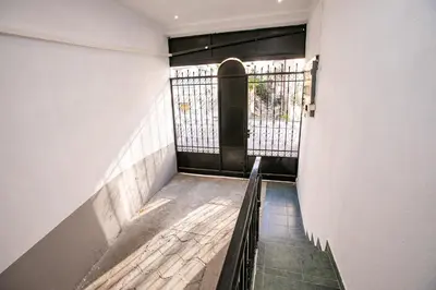a hallway with a black door in a building at Paradise Apartment in Sandanski