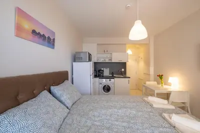 a living room with a bed and a kitchen at Sunny Dream Apartments in Sofia