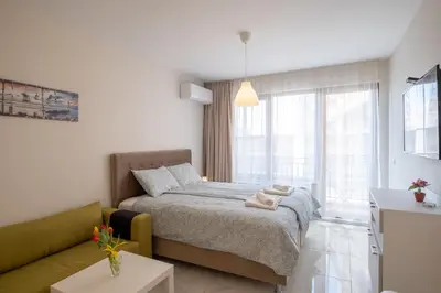 a bedroom with a bed and a couch at Sunny Dream Apartments in Sofia
