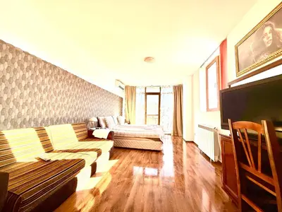 a living room with a couch and a bed at Family Hotel Carpe Diem in Banya