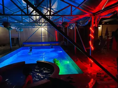 a indoor swimming pool with a person in the water at Family Hotel Carpe Diem in Banya